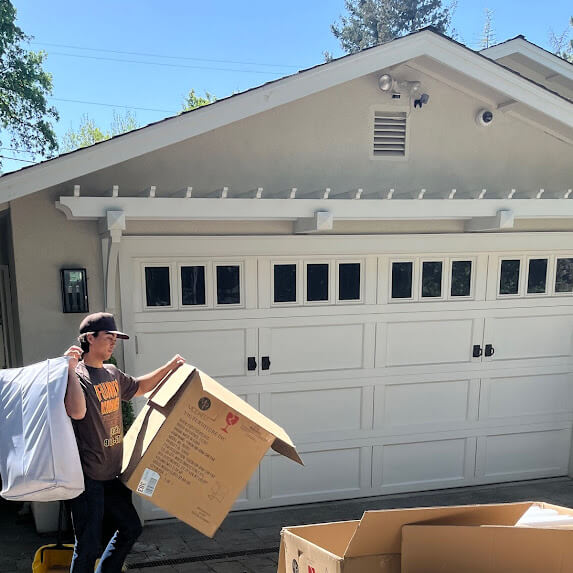 Man picking up cardboard boxes