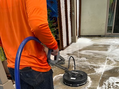 Man pressure washing a patio